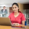 Sri Lankan businesswoman in modern office with computer, concentrating